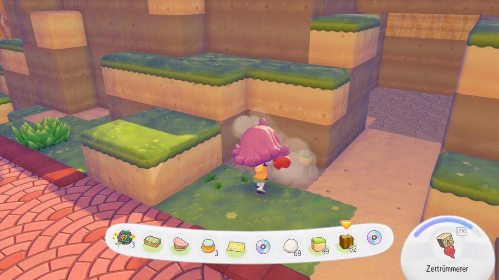 Dragon Quest Builders nur im Pokémon Universum? Meine Eindrücke zu Pokémon Pokopia! Screenshot aus Pokémon Pokopia: Eine Figur mit stylischer Frisur baut gerade Erdblöcke ab.
