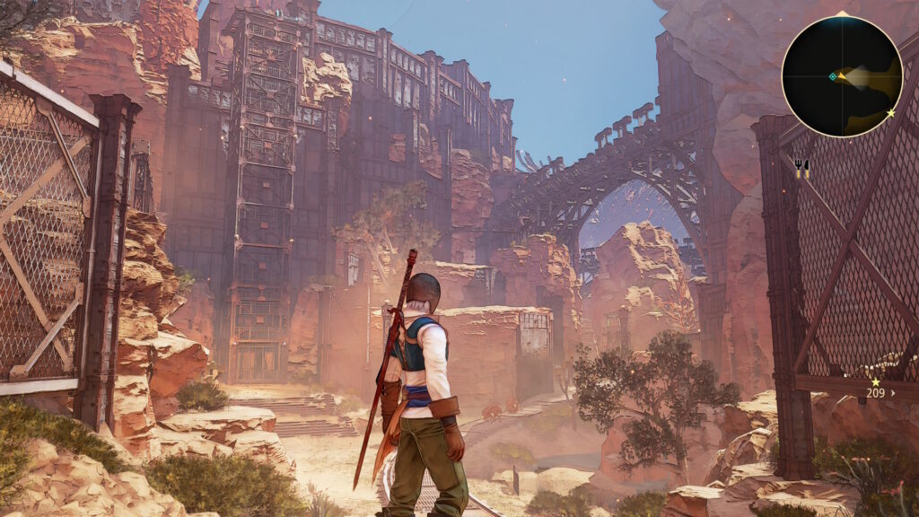 Screenshot aus dem game Tales of Arise. Zu sehen ist ein wolkenloser blauer Himmel und der Hauptcharakter des Spiels, welcher in einer trostlosen Gegend steht. In der Ferne ist eine Konstruktion zu sehen, ein Aufzug.